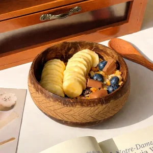 engraved coconut shell bowl filled with cereal and fruit