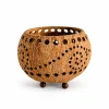 Coconut shell tealight candle holder with spiral perforations and rounded feet