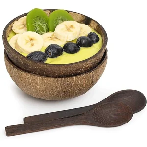 Natural coconut shell bowl with fruit smoothie and wooden spoons