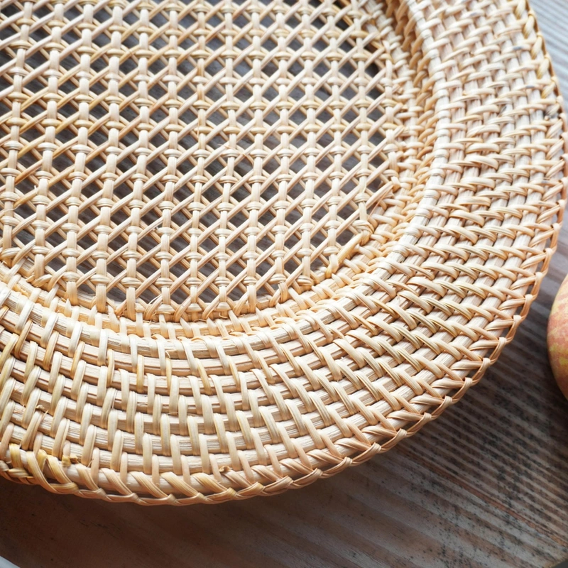 Close view of the lattice weave and wrapped rim on a rattan plate Close view of the lattice weave and wrapped rim on a rattan plate