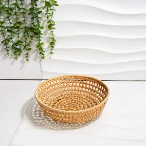 Close view of the open weave on a round natural rattan basket