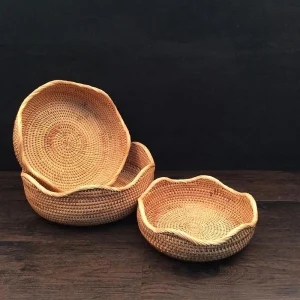 Three rattan trays showing petal-shaped rims and graduated sizes