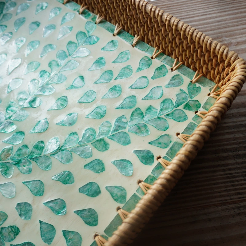 Close view of turquoise shell inlay and the woven rattan rim Close view of turquoise shell inlay and the woven rattan rim