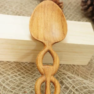 Close view of the Doussie Wood spoon bowl and carved handle
