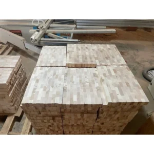 Wooden board blanks beside machinery during the production process