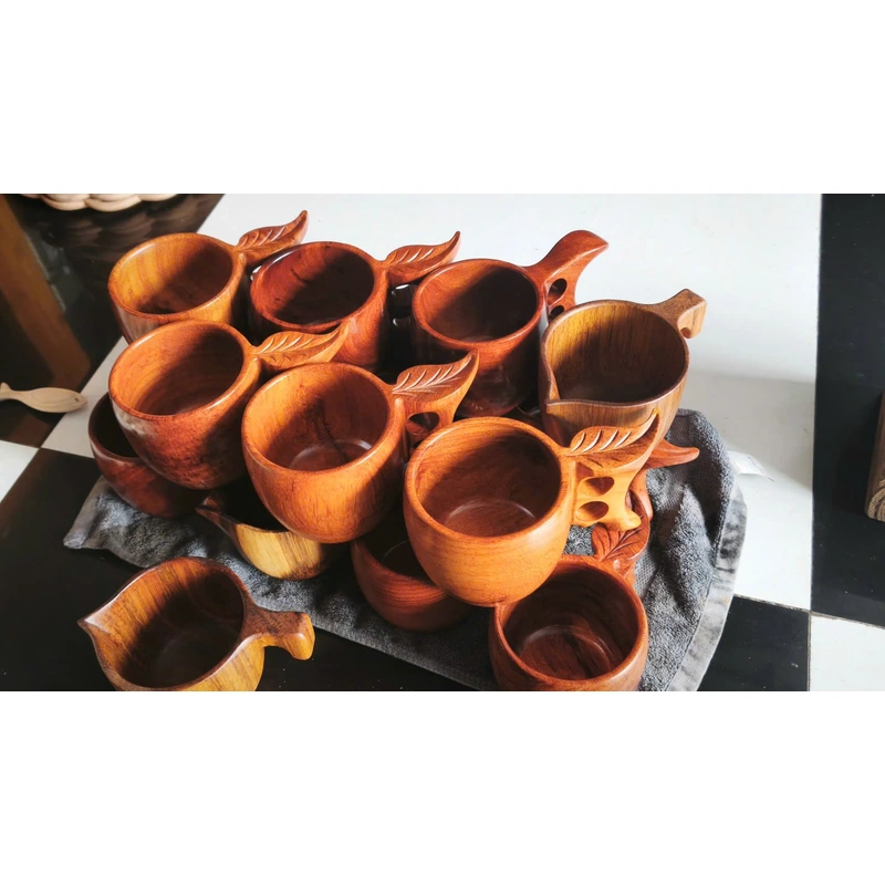 Collection of wooden cups with shaped handles at factory Collection of wooden cups with shaped handles at factory