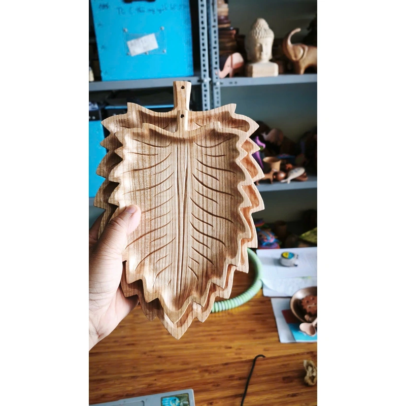 Carved leaf-shaped wooden tray from the factory collection Carved leaf-shaped wooden tray from the factory collection
