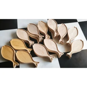 Light wooden fish-shaped trays from the factory collection
