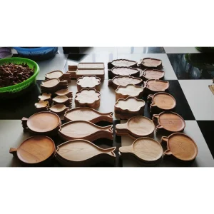 leaf and handled wooden trays laid out at the factory