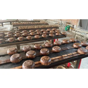 Walnut Color Rubberwood Bowl 3 Wooden bowls on racks during the production process