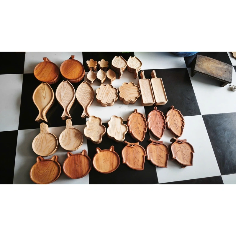 Collection of plain and carved wooden trays at the factory Collection of plain and carved wooden trays at the factory
