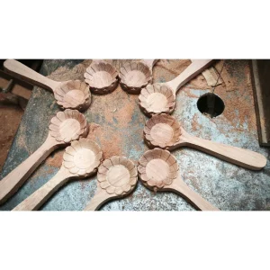 Round Ash Wood Scoop with Handle 4 Flower-shaped handled wooden bowls on a workshop bench