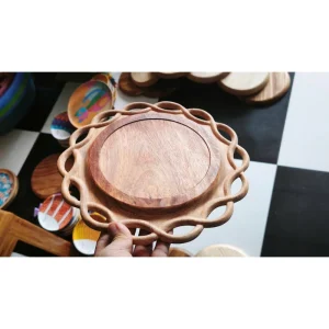 Round wooden tray with an open carved rim from the collection