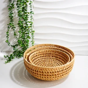 Three nested round rattan baskets showing their graduated sizes