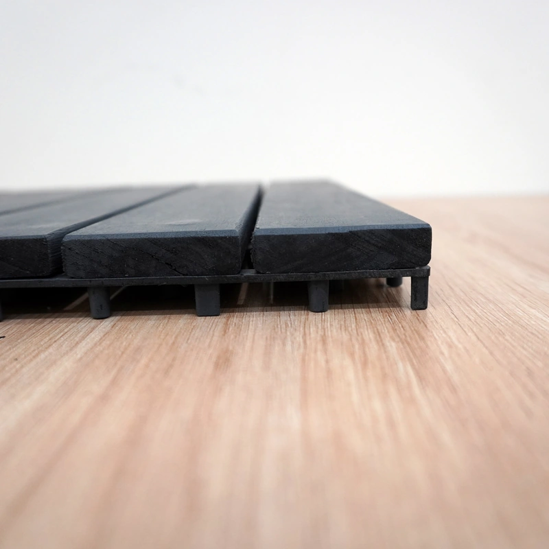 Close view of wood slat edges and the raised PP tile base Close view of wood slat edges and the raised PP tile base