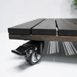 Close-up of the locking brake pedal and metal hub caster under the acacia platform