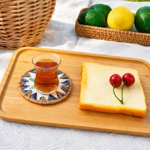 Wholesale Rattan Mother of Pearl Inlay Coasters 2 A glass of tea on a flower-pattern shell inlay coaster on a wooden tray