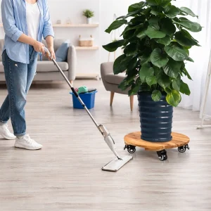 Wheeled acacia plant caddy holding a large planter while the floor is cleaned