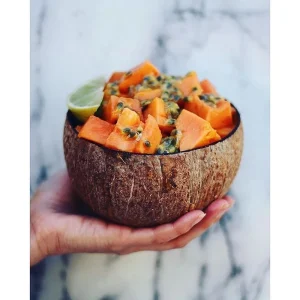 Natural Coconut Shell Bowl for Salad, Fruits, Cereal 2 Natural coconut bowl filled with papaya and passion fruit held in a hand