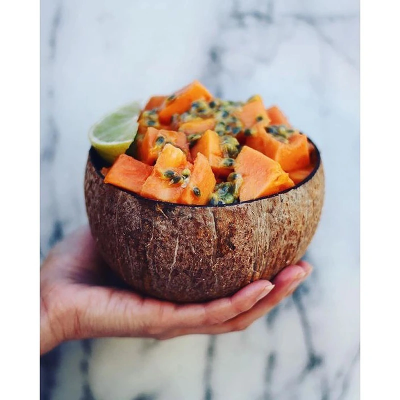 Natural Coconut Shell Bowl for Salad, Fruits, Cereal 6 Natural coconut bowl filled with papaya and passion fruit held in a hand