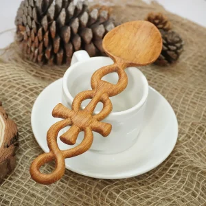 Hand-carved Doussie Wood spoon styled beside a white cup