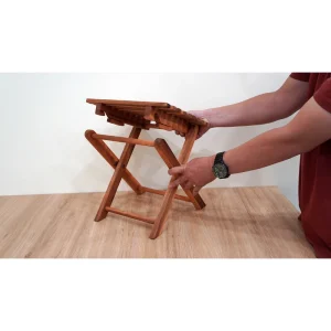 Folding Acacia Side Table with Slatted Top – 37 cm 2 Hands demonstrating how the cross legs of the acacia side table fold