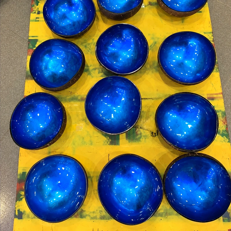 Blue Metallic Lacquer Coconut Bowl A group of blue lacquer coconut bowls, showing natural variation in shape and reflections.