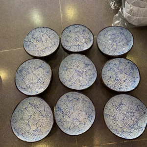 Several blue crackle eggshell bowls showing differences in natural shape and inlay placement.