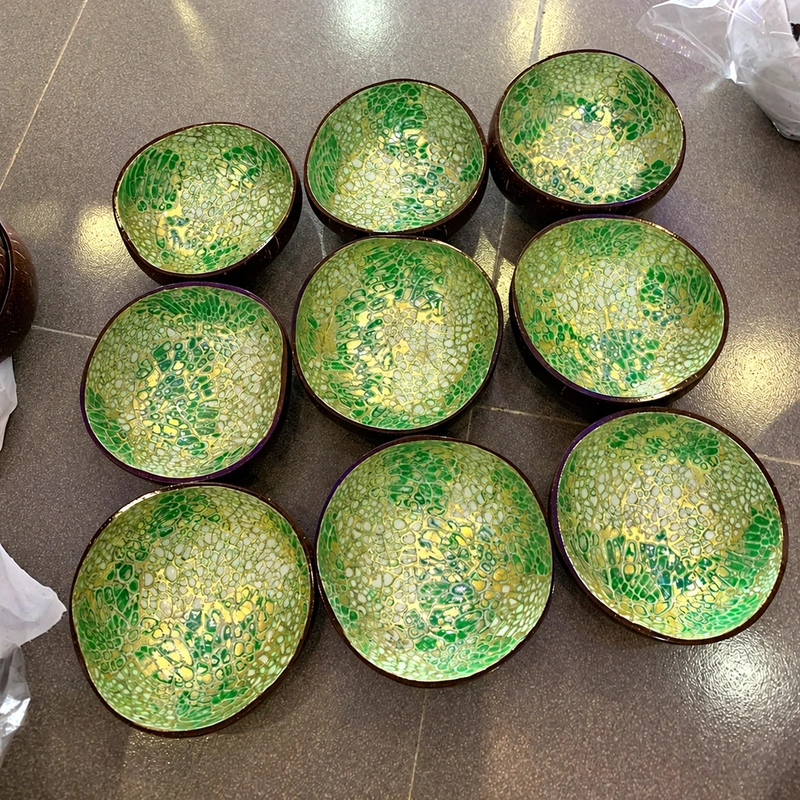Green Gold Eggshell Coconut Bowl 3 green gold eggshell coconut bowl A photographed batch of green and gold-coloured eggshell bowls; individual inlay and rim outlines vary.