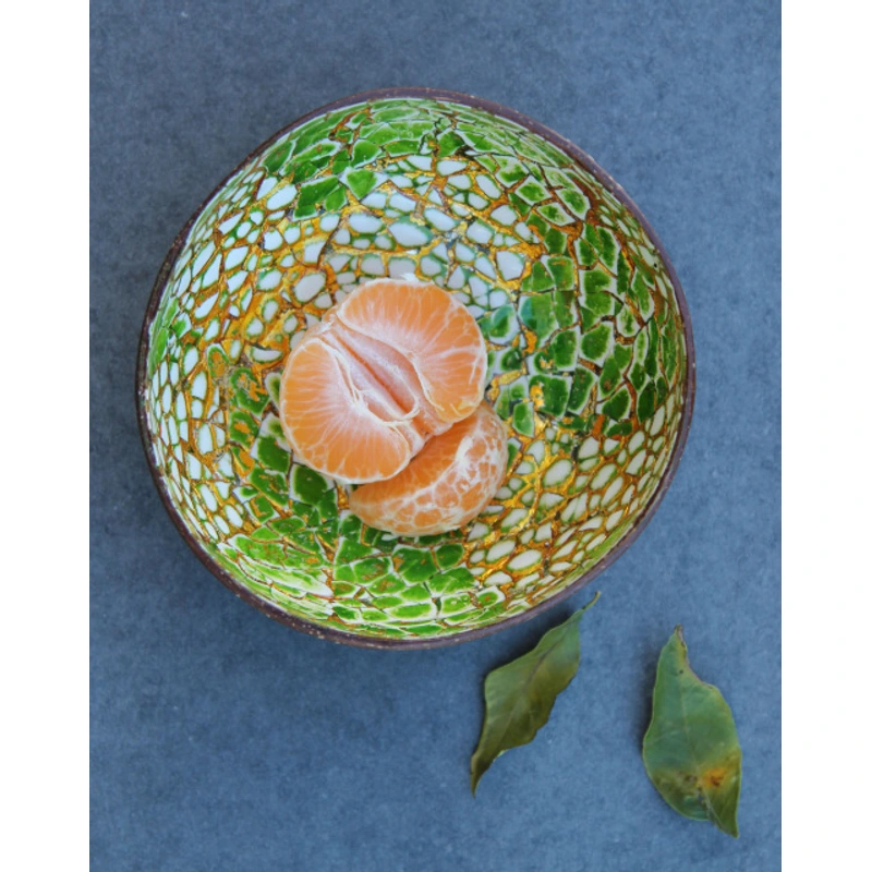 Green Gold Eggshell Coconut Bowl 4 Green Gold Eggshell Coconut Bowl reference photograph. Green and gold-coloured eggshell coconut bowl reference; handmade shell outlines and fragment placement vary. Fruit and leaves are styling props.