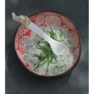 Red Mosaic Eggshell Coconut Bowl reference photograph. Red rounded-panel eggshell coconut bowl reference. Individual shell shapes and mosaic placement vary; food and accessories are presentation props.