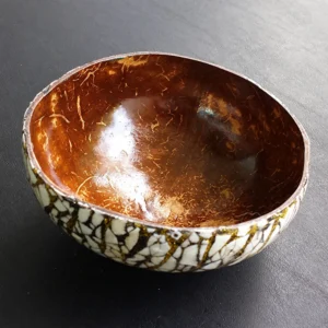 Exterior eggshell-inlaid coconut bowl reference; shell shape, shade and fragment layout differ between photographed samples.