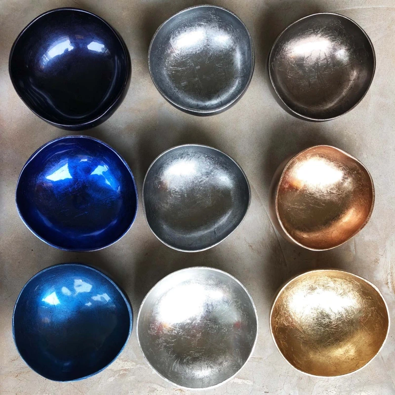 Silver Metallic Lacquer Coconut Bowl reference photograph. Silver-coloured lacquer coconut bowl reference; shell outlines and reflections vary. The collection photograph also includes separate blue, copper and gold-coloured finishes.