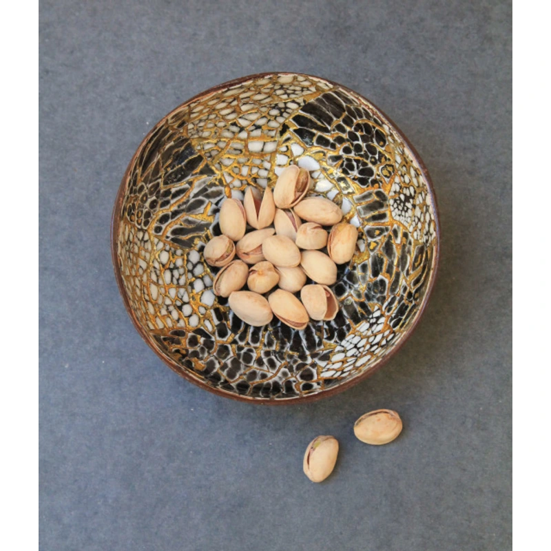 gold black eggshell coconut bowl Black and gold-coloured eggshell bowl styled with nuts; food use and accessories require separate confirmation.
