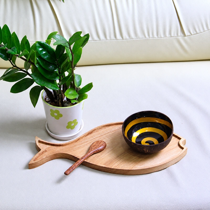 Gold Spiral Lacquer Coconut Bowl 4 gold spiral lacquer coconut bowl Gold-coloured spiral bowl on a wooden board; spoon, board and plant are presentation props.