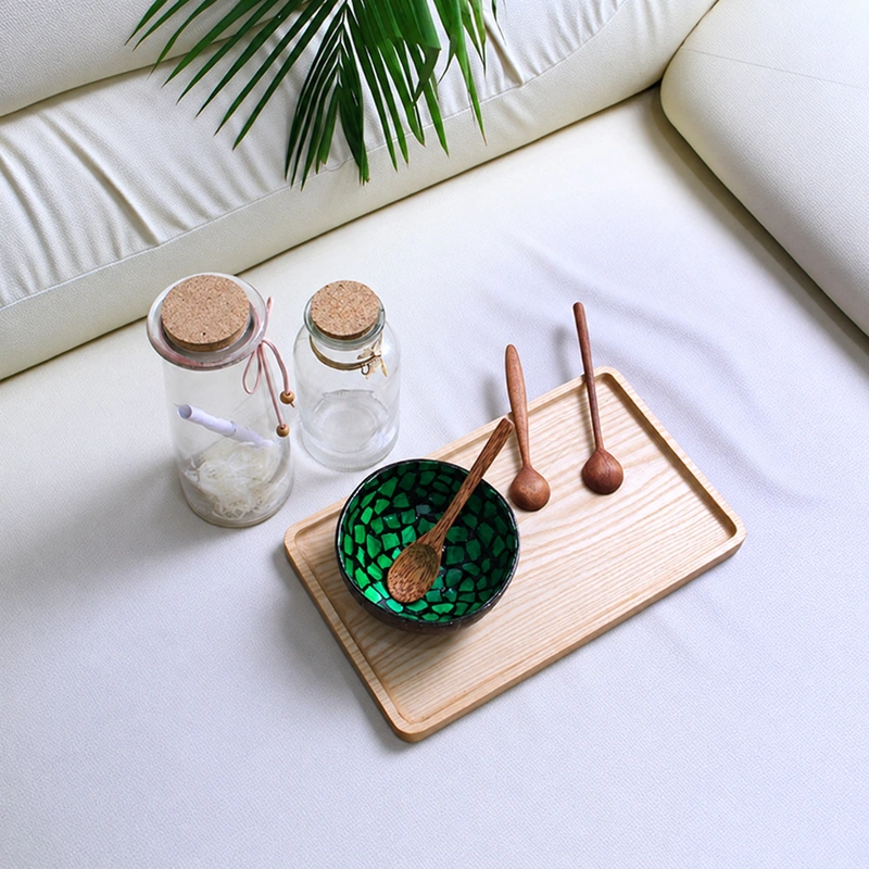 Green Fragment Pearl Coconut Bowl 4 green fragment pearl coconut bowl Angled styled view of the green fragment pearl bowl; tray, jars and spoons are props.