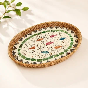 Oval woven tray with patterned inlay displayed beside a plant