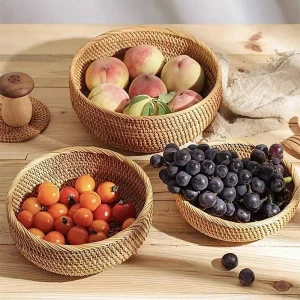 Natural rattan round fruit basket bowls holding fruit on a dining table