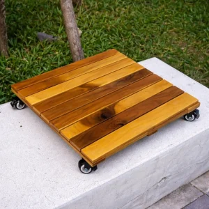 Wooden plant caddy carrying a potted plant on an outdoor patio