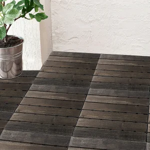 Walnut six-slat deck tiles beside a balcony plant
