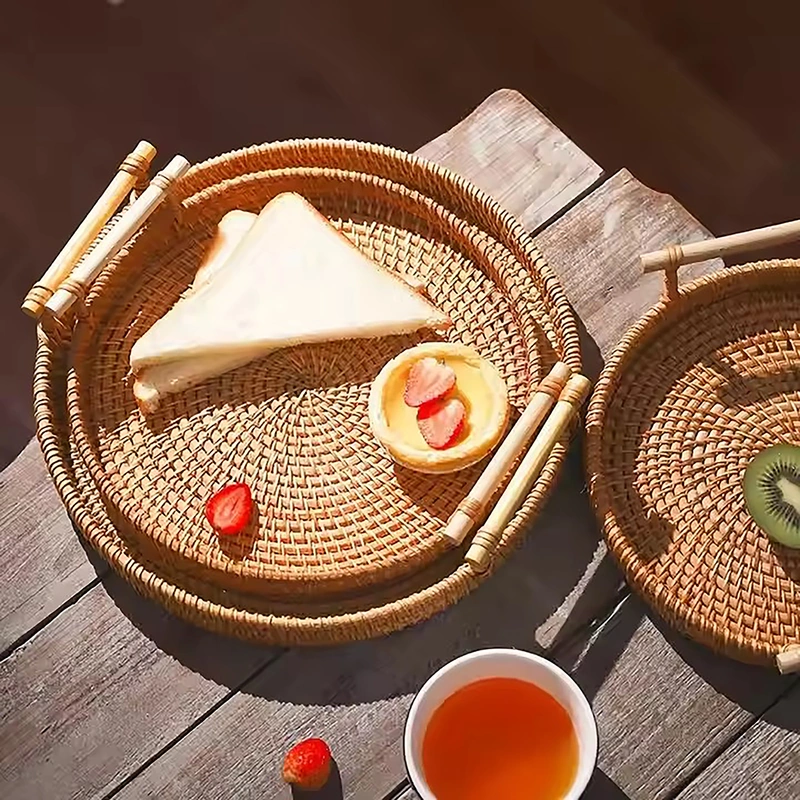 Wicker Basket, Round Dinner Plate with Handle 5 Wicker basket trays with bamboo handles styled with bread, fruit and tea