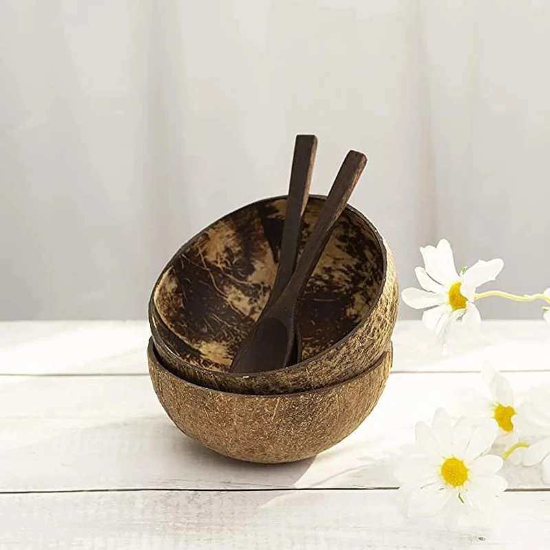 Natural Coconut Shell Bowl for Salad, Fruits, Cereal 5 Coconut shell bowl and wooden spoons styled on a table with flowers