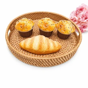 Rattan tray for coffee table display with bakery items and pink flowers