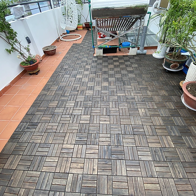High Quality Acacia Wood Deck Tiles - 12 Slats Walnut 5 Walnut wood deck tiles installed across a rooftop patio beside planters