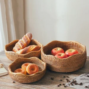 Round rattan fruit baskets holding bread and fruit on a table
