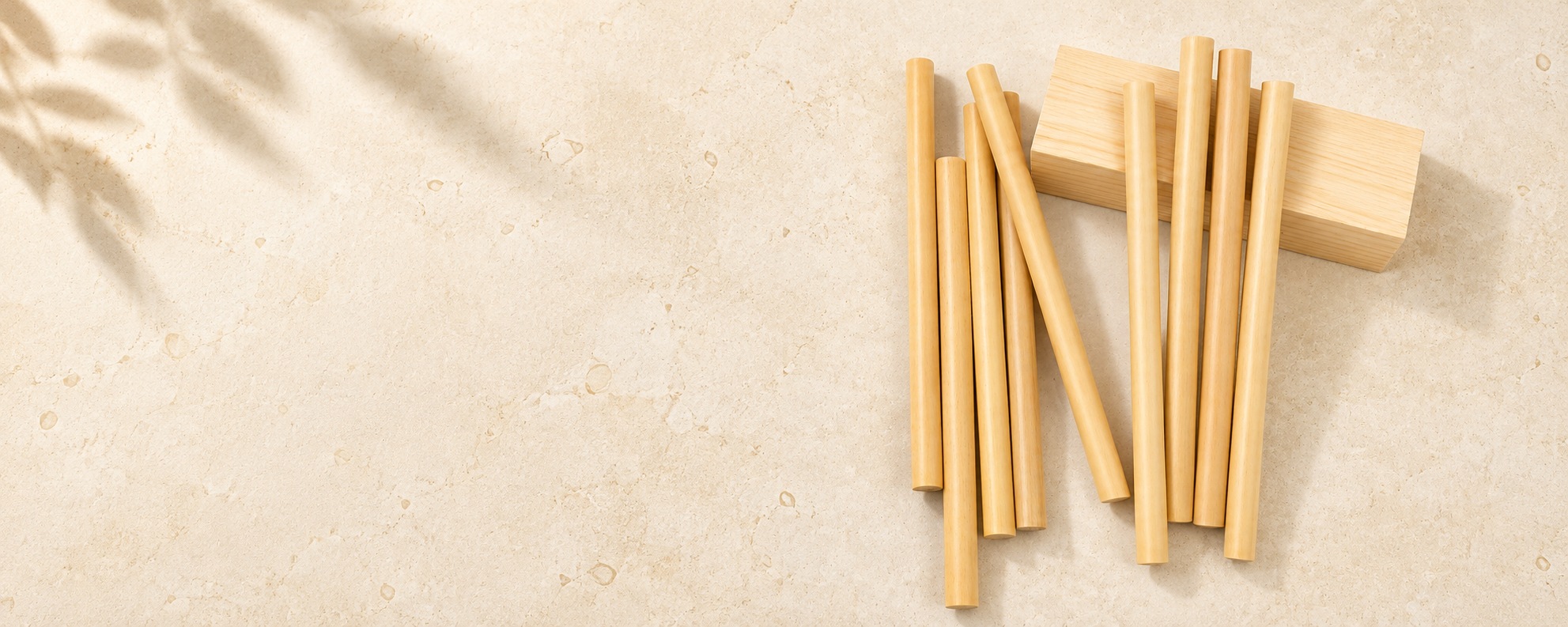 Natural bamboo drinking straws on a continuous cream stone surface