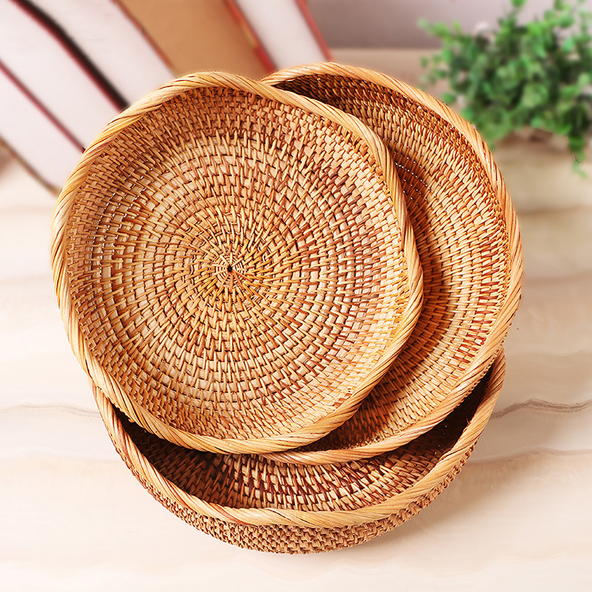 Three nested scalloped natural rattan trays
