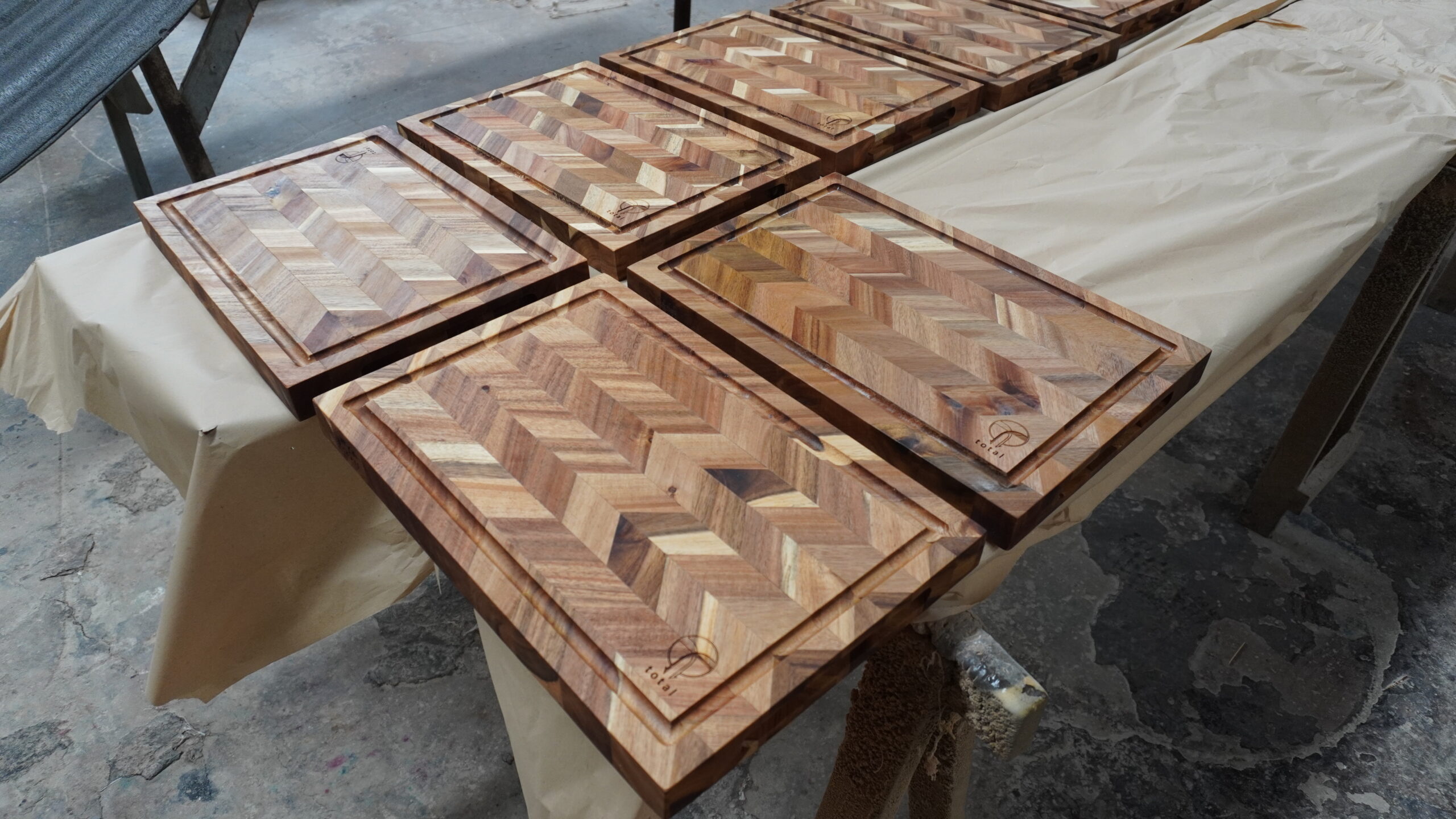 Herringbone wooden cutting boards arranged in the workshop