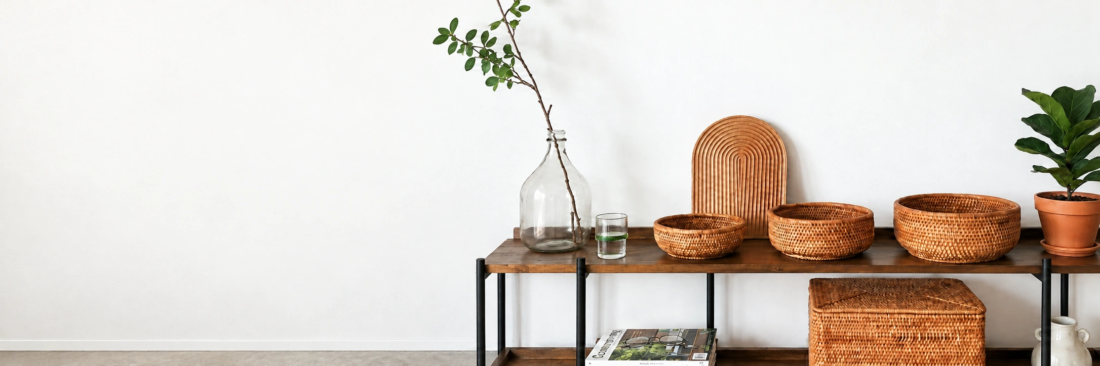 Handwoven rattan baskets displayed on a wooden shelf in a bright interior