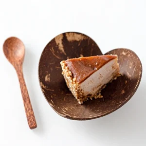 A heart-shaped shell bowl presented with cake; food and spoon are styling props.